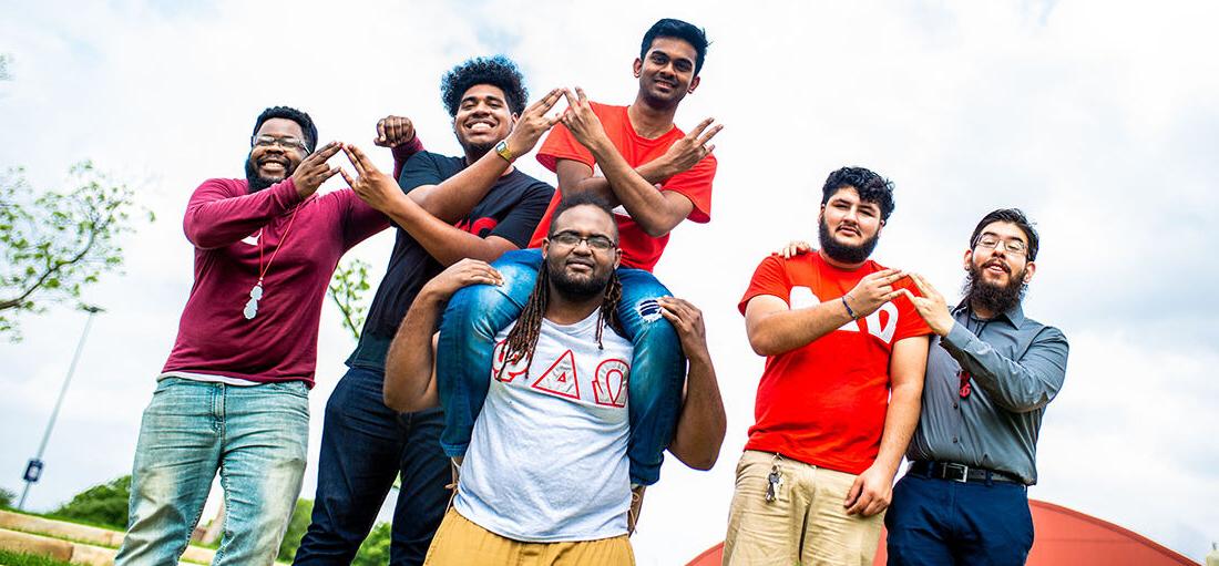 Group of students on a fraternity smiling at the camera.